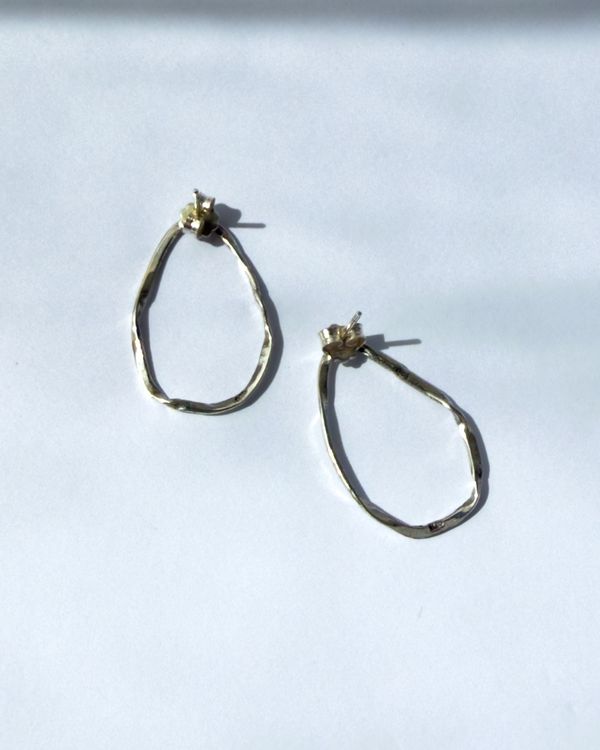 Nirakara hoops lying in window light