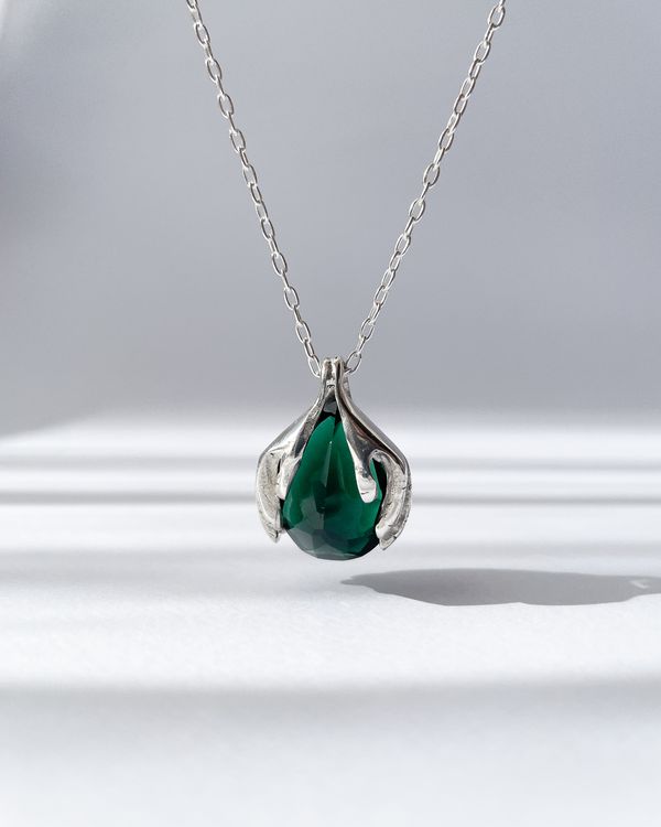 Rona pendant: two sterling silver hands holding a faceted green quartz teardrop