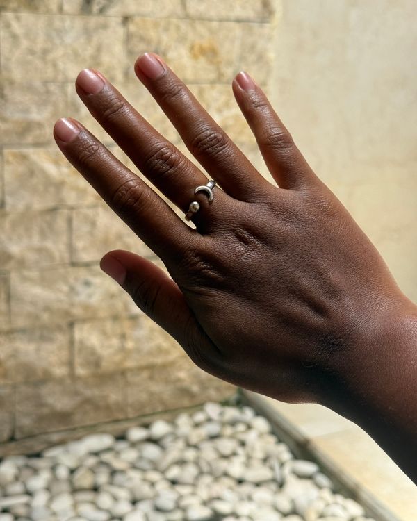 Gerhana ring worn against a stone wall in Ubud